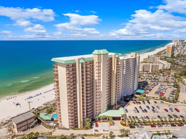 bird's eye view featuring a water view and a beach view