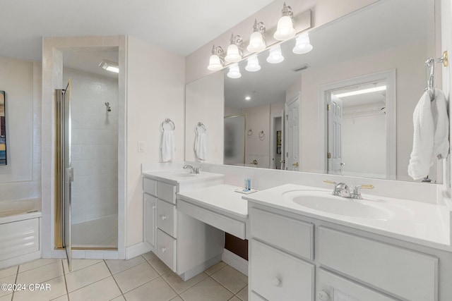 bathroom with a shower with shower door, tile flooring, and double sink vanity