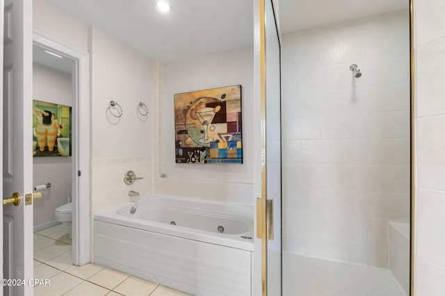 bathroom featuring tile floors, separate shower and tub, and toilet