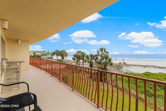 balcony with a beach view and a water view