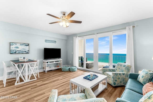 living room featuring hardwood / wood-style flooring and ceiling fan