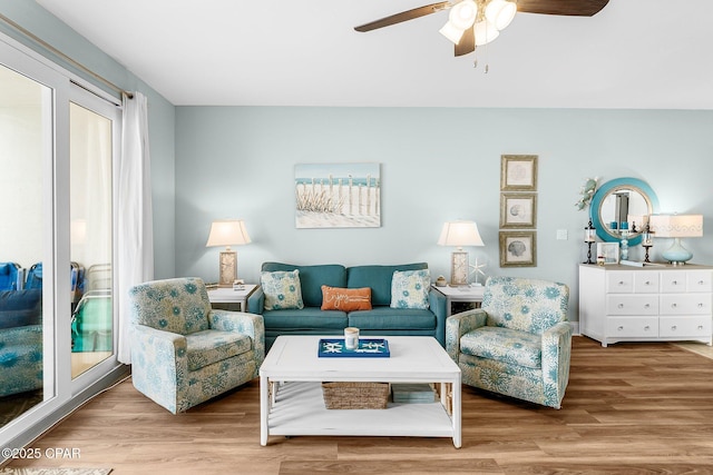 living room with hardwood / wood-style floors and ceiling fan