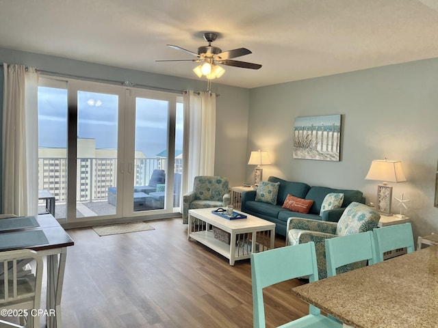 living room featuring wood-type flooring and ceiling fan