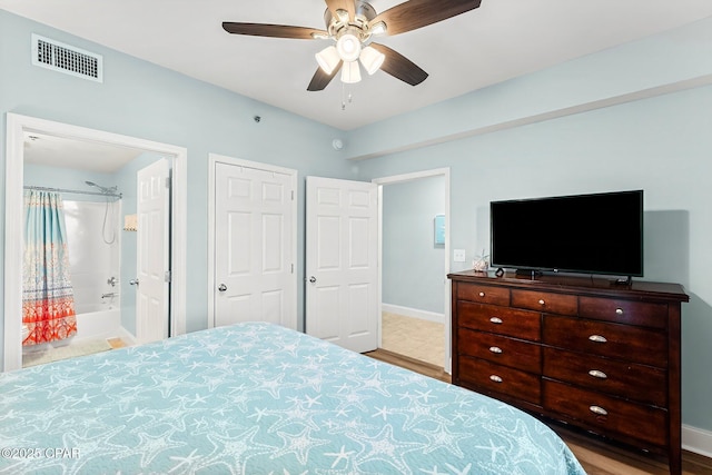 bedroom featuring ensuite bath and ceiling fan