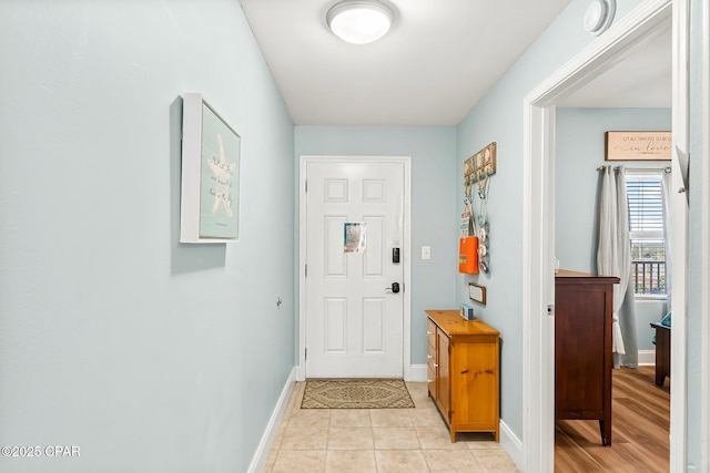 doorway with light tile patterned floors