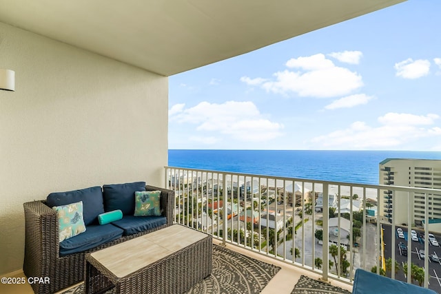 balcony with a water view and a beach view