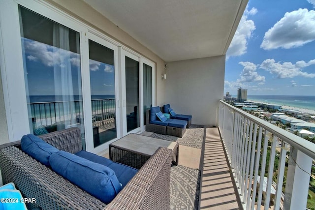 balcony featuring a water view and an outdoor living space