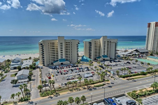 birds eye view of property with a water view and a beach view