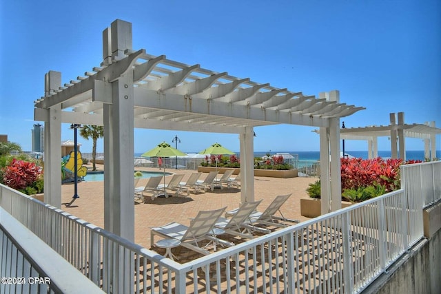 view of patio / terrace with a pergola and a water view