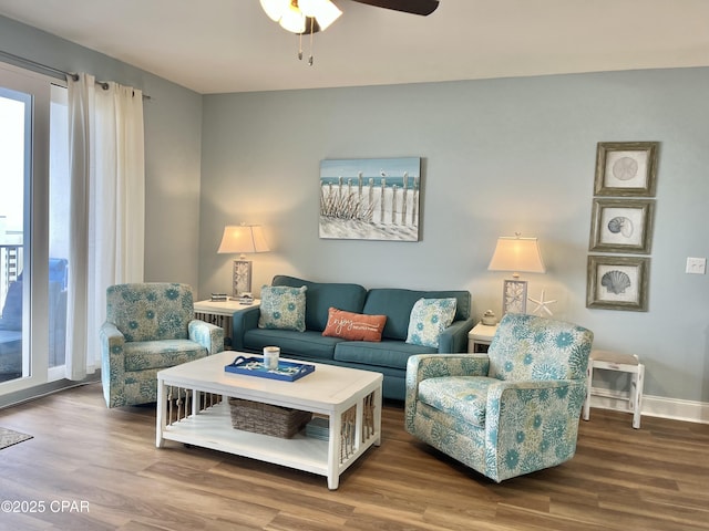 living room featuring hardwood / wood-style floors and ceiling fan