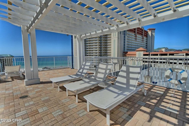 view of patio featuring a water view and a pergola