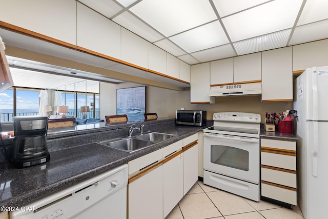 kitchen featuring white cabinets, white appliances, and sink