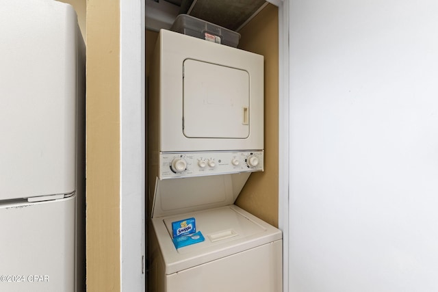 laundry room with stacked washer and dryer