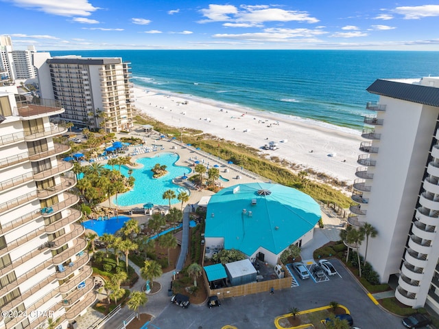 drone / aerial view featuring a water view and a view of the beach