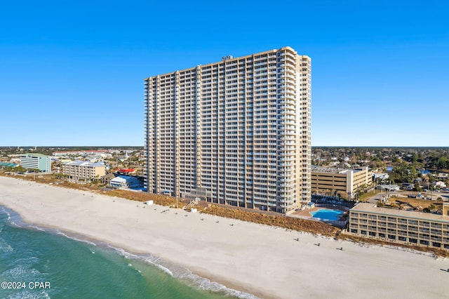 exterior space featuring a beach view and a water view