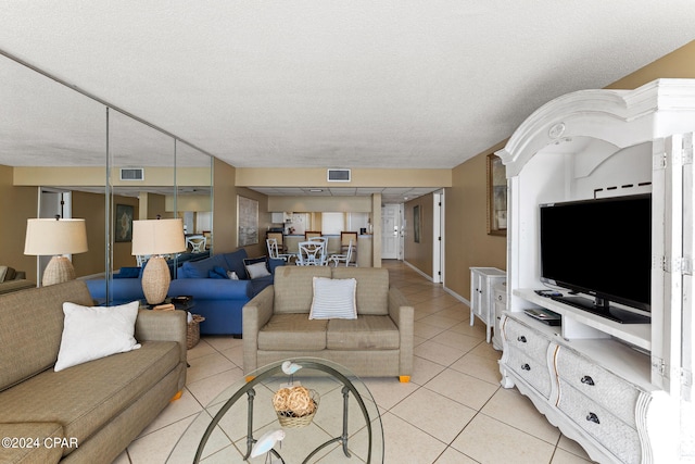 tiled living room featuring a textured ceiling