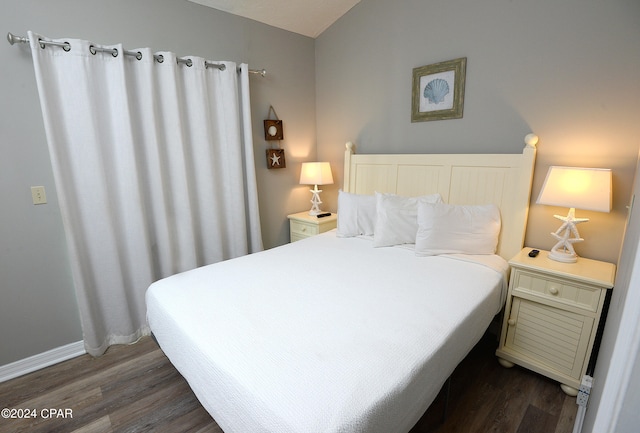 bedroom with dark hardwood / wood-style flooring