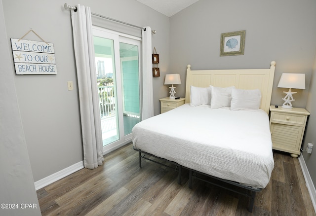 bedroom featuring dark wood-type flooring and access to exterior