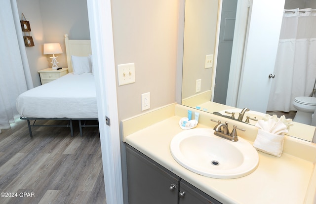 bathroom with vanity, hardwood / wood-style flooring, and toilet