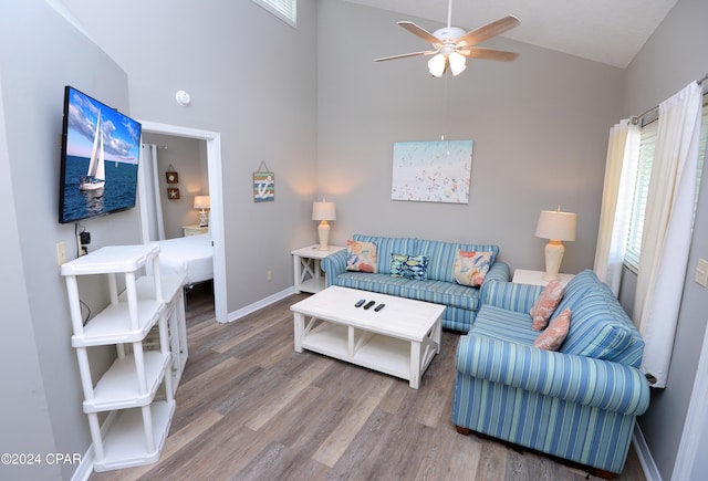 living room with lofted ceiling, wood-type flooring, and ceiling fan