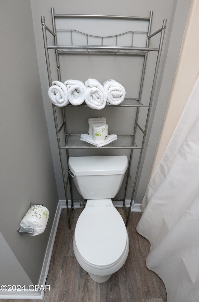 bathroom featuring hardwood / wood-style floors and toilet