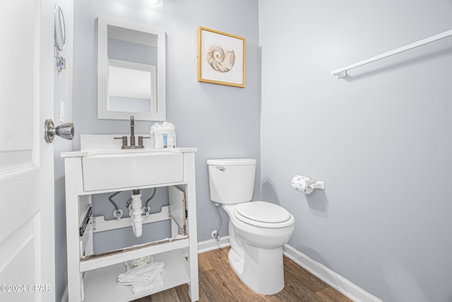 bathroom with vanity, toilet, and hardwood / wood-style flooring