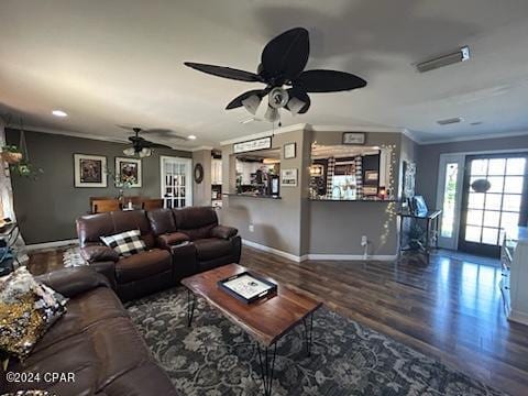 kitchen featuring white cabinets, dark hardwood / wood-style floors, crown molding, and hanging light fixtures