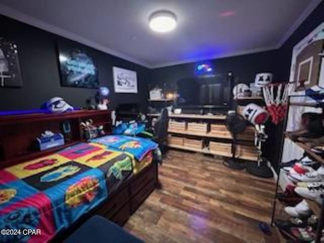 bedroom with wood-type flooring and crown molding