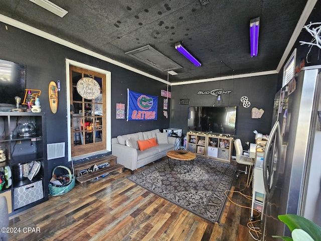 living room with ornamental molding and hardwood / wood-style floors