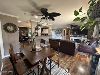 dining space featuring ceiling fan, hardwood / wood-style flooring, and ornamental molding