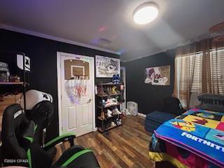 bedroom featuring crown molding and hardwood / wood-style floors