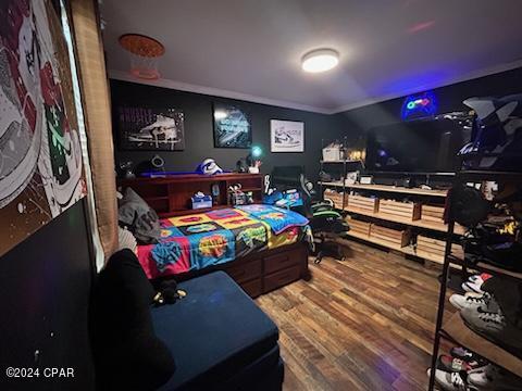 recreation room with hardwood / wood-style flooring and ornamental molding