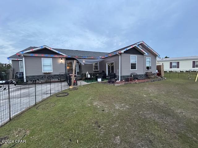 view of front of house featuring a patio area and a front lawn