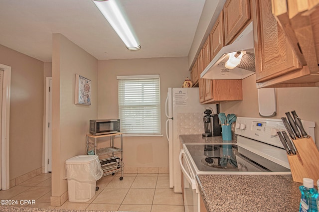 kitchen featuring light tile flooring and white electric stove