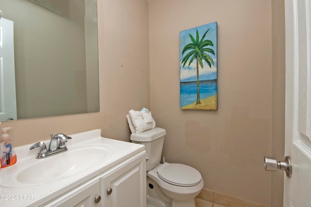 bathroom with vanity with extensive cabinet space, toilet, and tile flooring