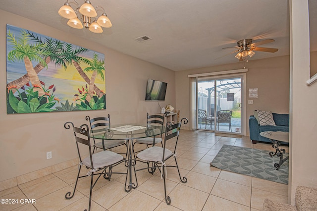 dining area with ceiling fan with notable chandelier and light tile flooring