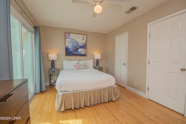 bedroom with light hardwood / wood-style flooring and ceiling fan