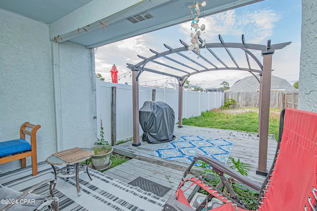 view of patio featuring a deck, a pergola, and a grill