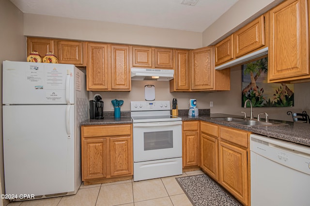 kitchen with white appliances, sink, and light tile floors