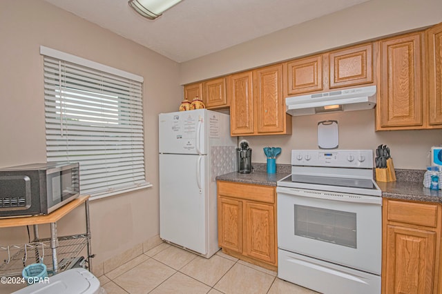 kitchen featuring white appliances and light tile flooring