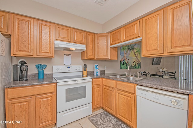 kitchen featuring white appliances, sink, and light tile floors