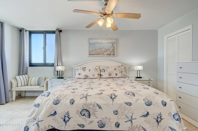 bedroom featuring a closet, ceiling fan, and light tile floors