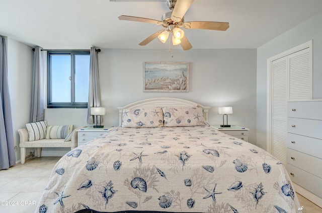 tiled bedroom featuring ceiling fan and a closet