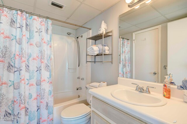 full bathroom featuring vanity, toilet, a paneled ceiling, and shower / bath combination with curtain