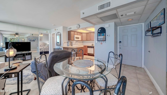 dining area with ceiling fan and light tile flooring