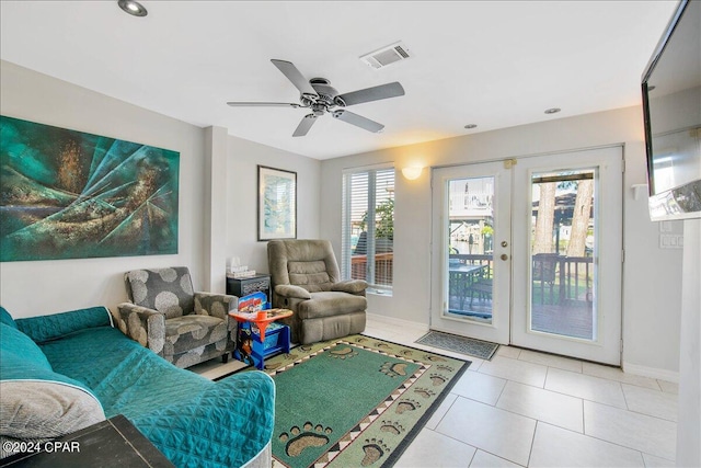 tiled living room featuring french doors and ceiling fan