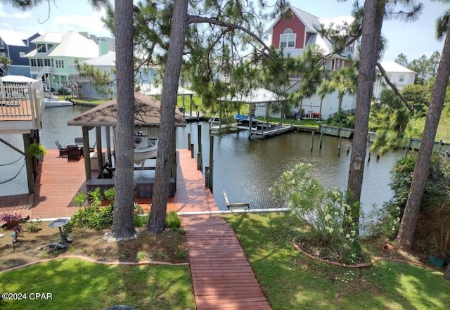 view of dock with a yard and a water view