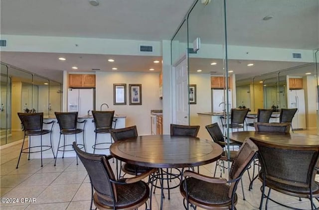 dining space featuring light tile flooring