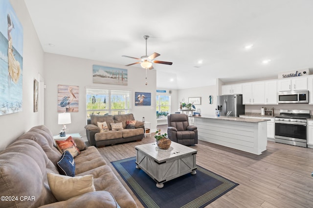 living room featuring ceiling fan and light hardwood / wood-style floors