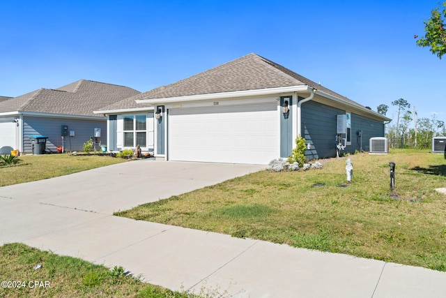 ranch-style home with central AC unit, a garage, and a front yard